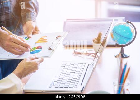 Business adviser analyzing financial figures denoting the progress in the work with team. Stock Photo