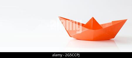 Red paper boat isolated on white background, banner with copy space Stock Photo