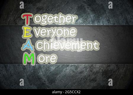 team meaning written on blackboard background, high Stock Photo