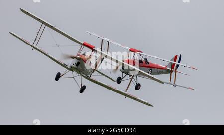 2 RAF Central Flying School marked Tiger Moths airborne at Shuttleworth Evening airshow on the 19th June 2021 Stock Photo