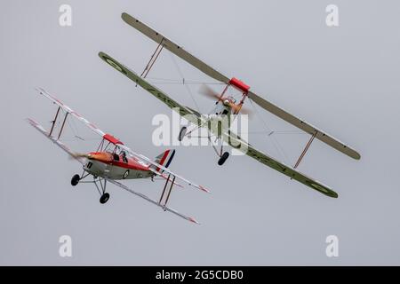 2 RAF Central Flying School marked Tiger Moths airborne at Shuttleworth Evening airshow on the 19th June 2021 Stock Photo