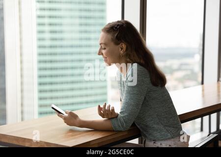 Happy beautiful woman using mobile phone applications. Stock Photo