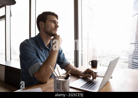 Thoughtful millennial generation male manager working on computer. Stock Photo