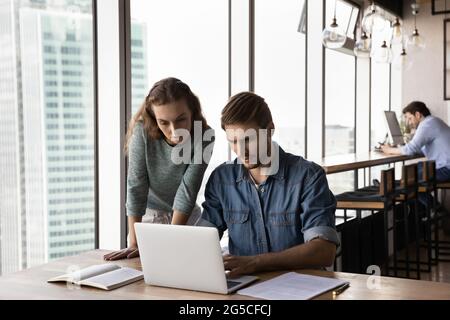 Focused smart workers analyzing online sales in modern office. Stock Photo