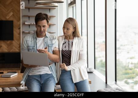 Concentrated young employees working on online computer project. Stock Photo