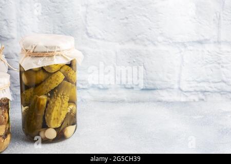 Preservation of vegetables in banks. Fermentation products. Harvesting cucumbers for the winter. Copy space Stock Photo