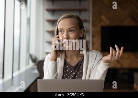 Smiling young business lady holding phone call conversation. Stock Photo