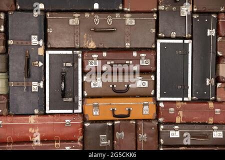 Wallpaper banner with folded old-fashioned antique leather suitcases. Stock Photo