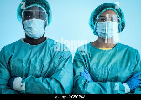 Multiracial doctors wearing personal protective equipment fighting against corona virus outbreak - Health care and medical workers concept Stock Photo