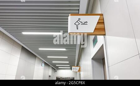 Public toilet sign for restroom. Baby changing facilities and feeding area. Men, women and disabled lavatory on blurred background. Stock Photo