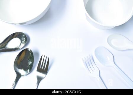 stainless and plastic spoon with bowl for single used on white background Stock Photo