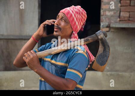 Indian farmer talking on smart phone Stock Photo