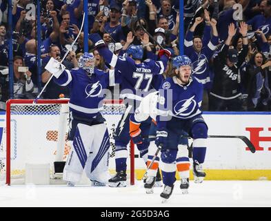 Tampa, USA. 25th June, 2021. Tampa Bay Lightning goaltender Andrei Vasilevskiy (88) celebrates along with defenseman Victor Hedman (77) and defenseman Mikhail Sergachev (98) as the Lightning beat the New York Islanders in Game 7 of the Stanley Cup semifinals at Amalie Arena on Friday, June 25, 2021 in Tampa. (Photo by Dirk Shadd/Tampa Bay Times/TNS/Sipa USA) Credit: Sipa USA/Alamy Live News Stock Photo
