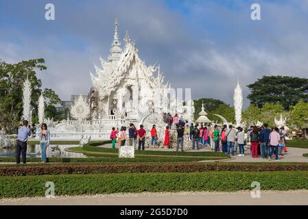 CHIANG RAI, THAILAND - DECEMBER 16, 2018: Tourists at the futuristic Buddhist temple Wat Rong Khun (White Temple) Stock Photo