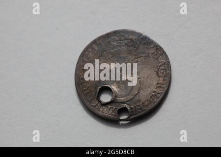 Close-up of a worn British Coin - A Queen Anne Royal Maundy Silver Threepence dating from 1702- 1707 which has been pierced Stock Photo