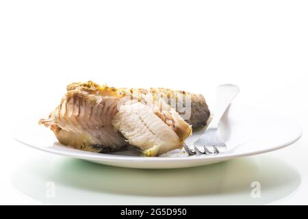 fish baked in the oven with spices, spices isolated on white background Stock Photo