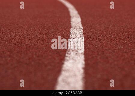 Red racing track with white line rubber texture in stadium texture background Stock Photo
