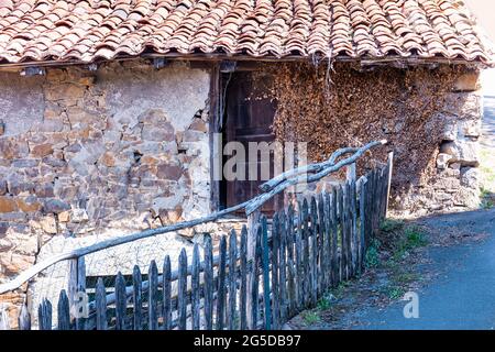 View of an apparently abandoned old house in a village in Asturias, Spain.Photograph with a predominantly brownish tone and shot in horizontal format. Stock Photo