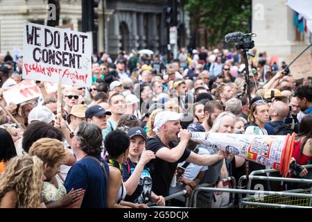 London, UK. 26th June, 2021. A protester with a cone shouts at the the police guarding Downing Street. Thousands of people marched to raise their concerns regarding government legislation centred around vaccinations and freedom to travel. Credit: Andy Barton/Alamy Live News Stock Photo