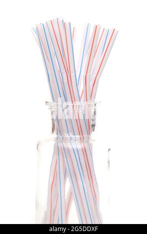 Bunch of Straws in a Glass Container on a White Background Stock Photo