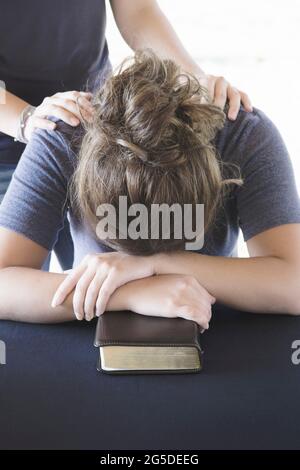 Comforting a Distressed Woman During a Bible Study Stock Photo