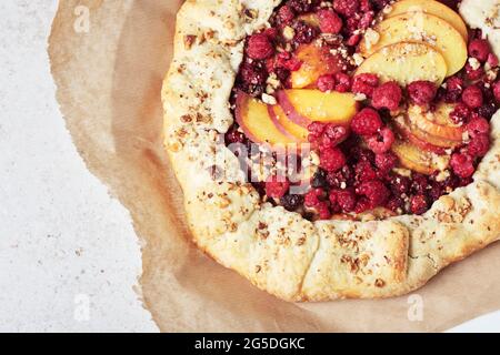 Raspberry tart, open pie on a light background. Stock Photo