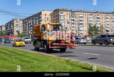 Sweeper machine on the road in the city (street sweeper). Community road services, street cleaning concept. Moscow, Russia Stock Photo