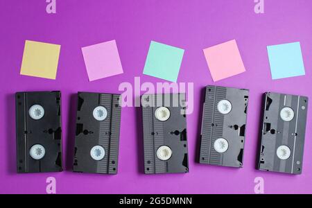 Retro style, pop art concept. Audio cassettes and memo paper on purple background. Top view. Copy space Stock Photo
