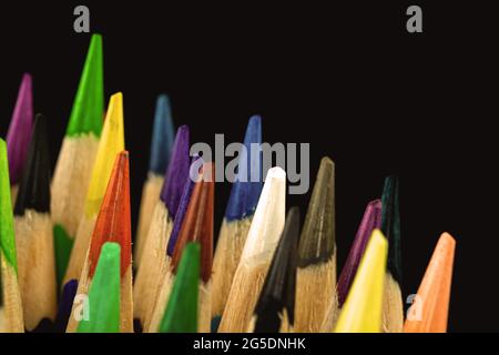 Sharp tips of the color pencils close-up and macro photography, black background photo Stock Photo
