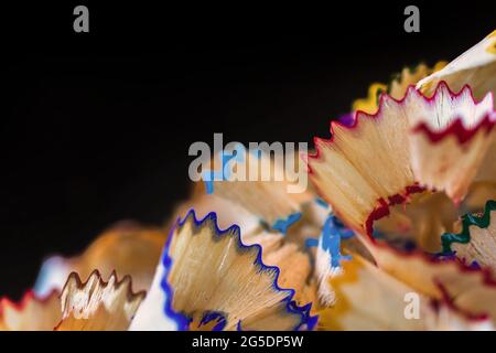 A lot of the color pencils shavings on the back background, close-up and macro Stock Photo