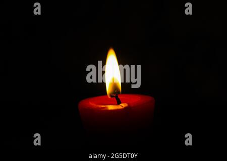 lighting candles, Burning candle on black background, Candle in the dark, Design for the background and wallpaper. copy space. Stock Photo