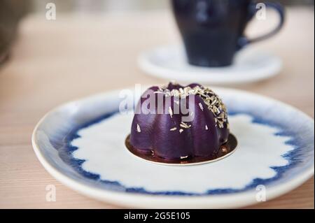 Homemade vegan mousse dessert on a plate on the counter top of bakery or pastry cafe Stock Photo