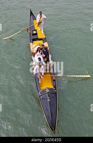 Newlyweds in a gondola on the grand canal in Venice Stock Photo