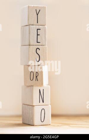 Yes versus no inscription on wooden cubes, balance,positivity,answers and question concept with copy space modern background