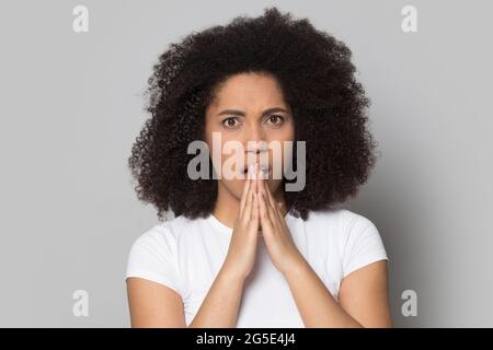 Portrait of unhappy biracial woman shocked by bad news Stock Photo