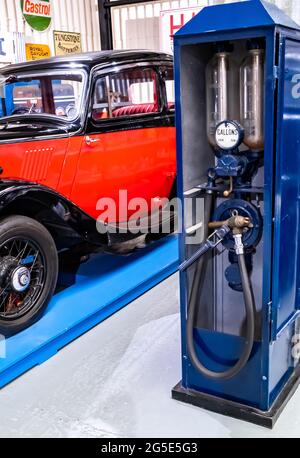 Yeovil, Somerset, UK – June 18 2021. An old fashioned and vintage gas or petrol pump in a garage or workshop Stock Photo