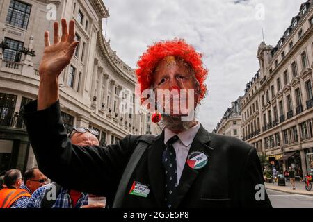 London,  UK on June 26, 2021: Anti-government activists  protest at Regent Street in the centre of the city. The protest unites activists from many opposition left wing movements such as Kill the Bill, The People's Assembly, NHS Staff Voices, Stop the War Coalition or Extintion Rebellion. Stock Photo