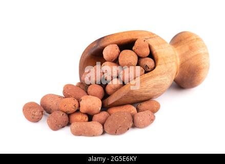Expanded clay drainage in wooden scoop, isolated on white background. Whole brown clay pebbles. Stock Photo