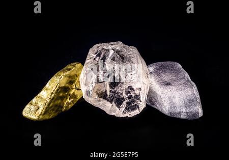 silver ore, gold nugget and rough diamond on black isolated background. Stock Photo