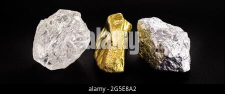 Rough diamond stone with rough gold and silver nuggets on isolated black background. Stock Photo