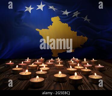 Mourning candles burning on Kosovo national flag of background. Memorial weekend, patriot veterans day, National Day of Service Remembrance. Burning c Stock Photo