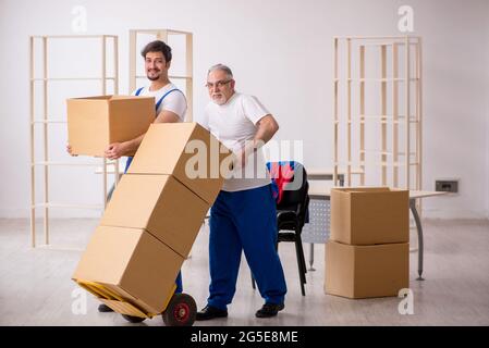 Two professional movers doing home relocation Stock Photo