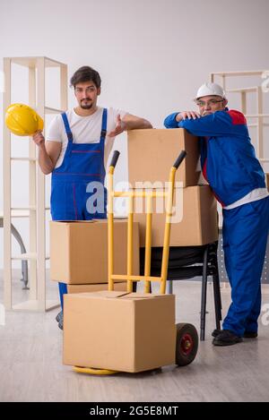 Two professional movers doing home relocation Stock Photo