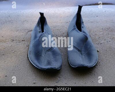 swimming slippers on the sand close-up Stock Photo