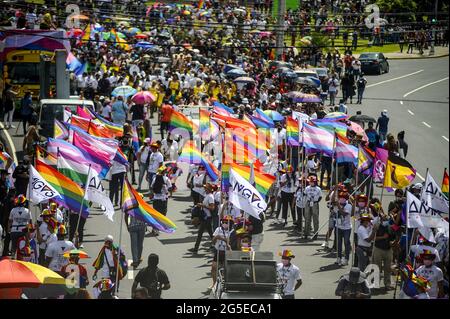 San Salvador, El Salvador. 26th June, 2021. Participants seen with flags and banners, during the Pride March.Members of the LGBT community took to the streets to perform in an annual Pride Parade celebrating diversity and protest for human rights laws to be approved by Congress. (Photo by Camilo Freedman/SOPA Images/Sipa USA) Credit: Sipa USA/Alamy Live News Stock Photo