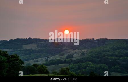 sun setting over the Blackwall Range at Coolgardie, a coastal mountain range on the North Coast of New South Wales, near Ballina, Australia Stock Photo