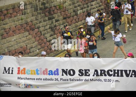 San Salvador, El Salvador. 26th June, 2021. Demonstrators march while holding a banner for an identity law to be passed by Congress. Members of the LGBT community march to celebrate pride day months after the Salvadoran Congress archived various law's that would benefit the LGBT community. Credit: Camilo Freedman/ZUMA Wire/Alamy Live News Stock Photo