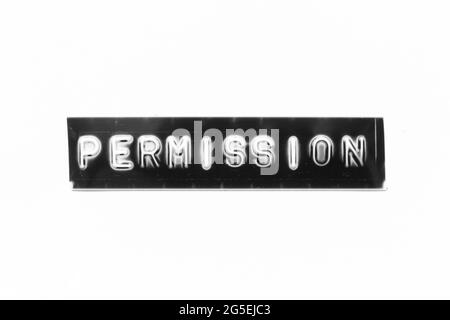 Embossed letter with word permission in black banner on white paper background Stock Photo