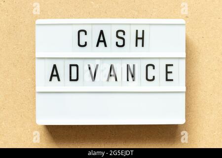 Lightbox with word cash advance on wood background Stock Photo