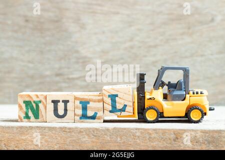 Toy forklift hold letter block l to complete word null on wood background Stock Photo